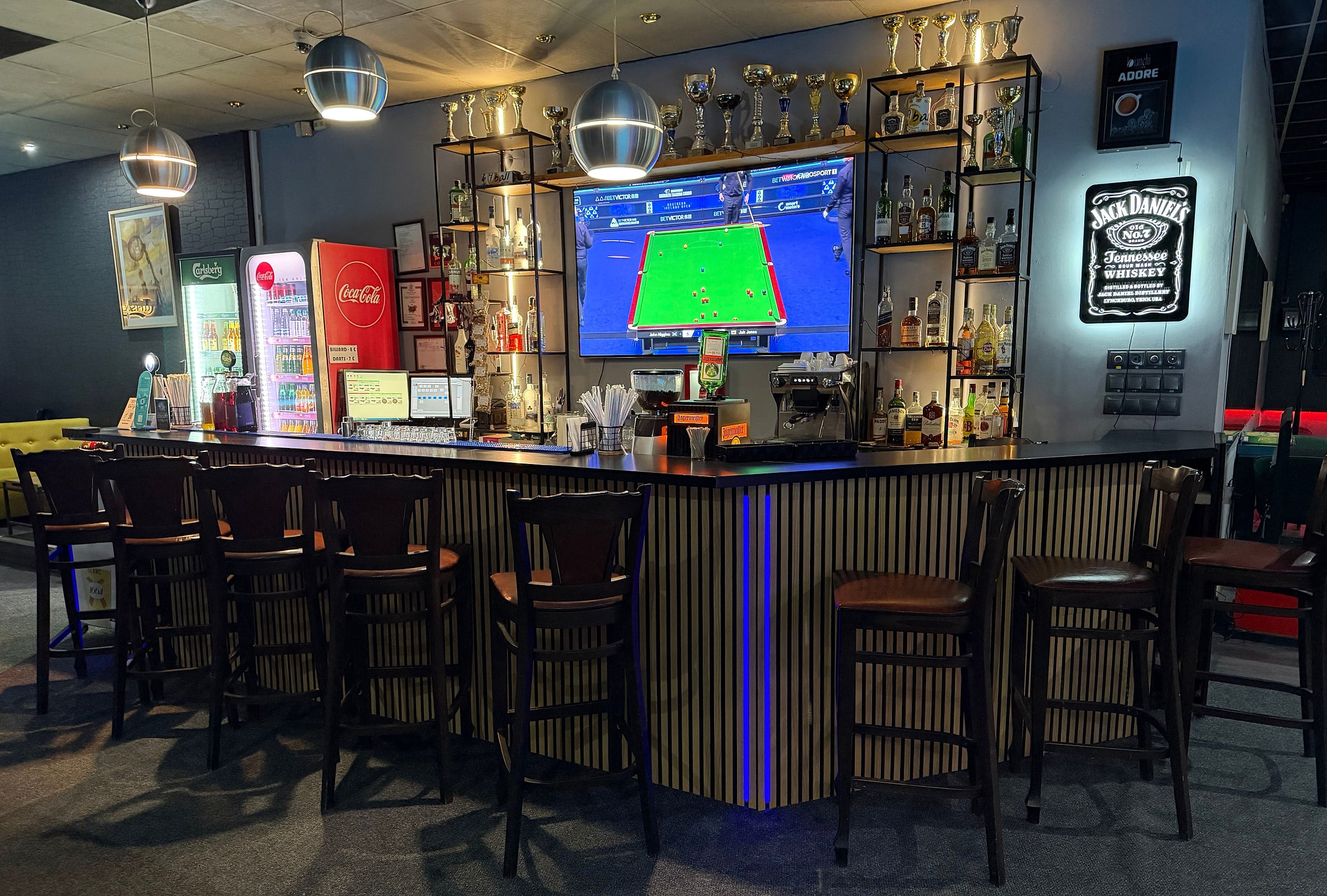 The bar: the counter, the stools and the trophies above the shelves