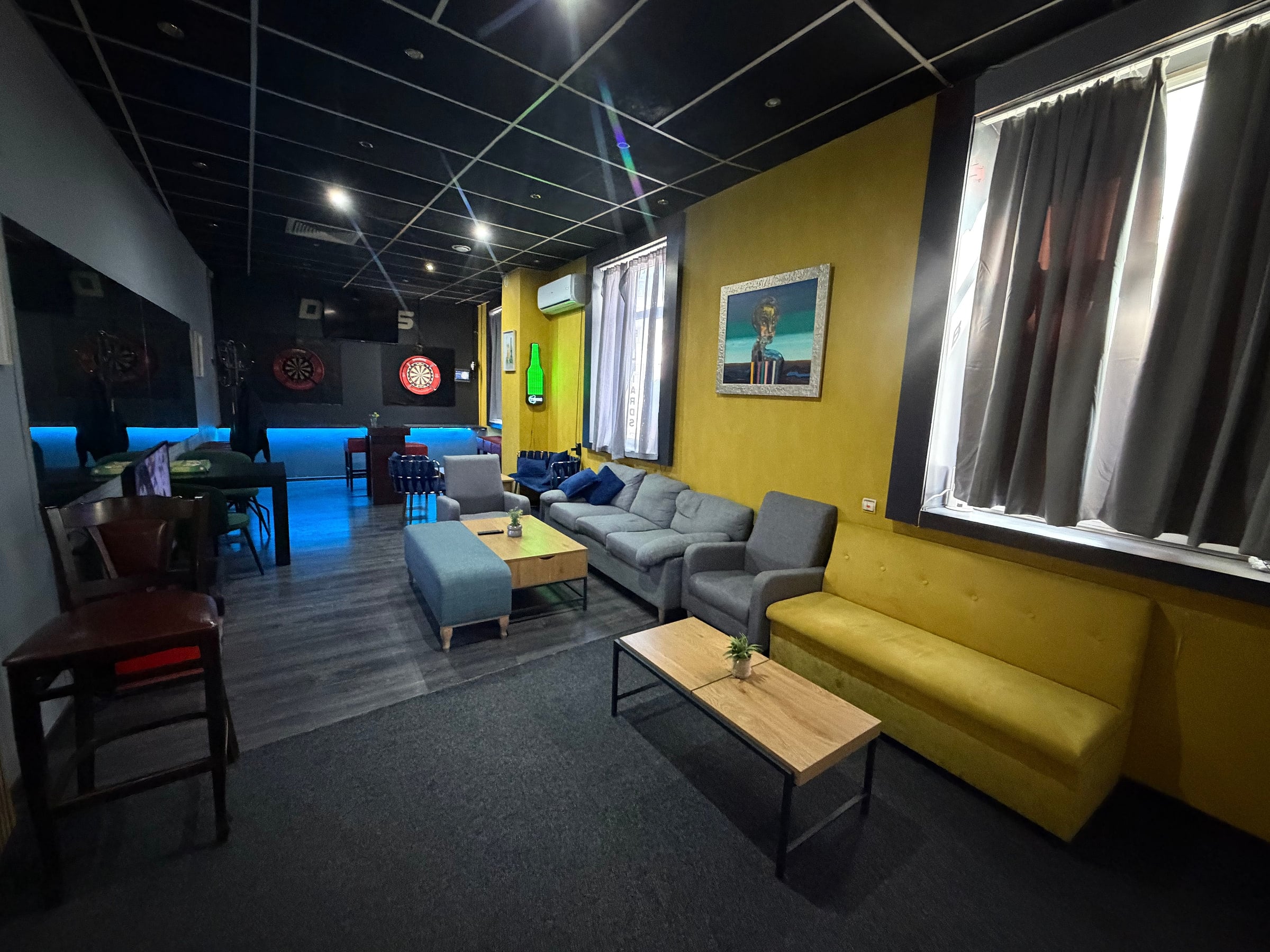 The lounge: sofas against the yellow wall