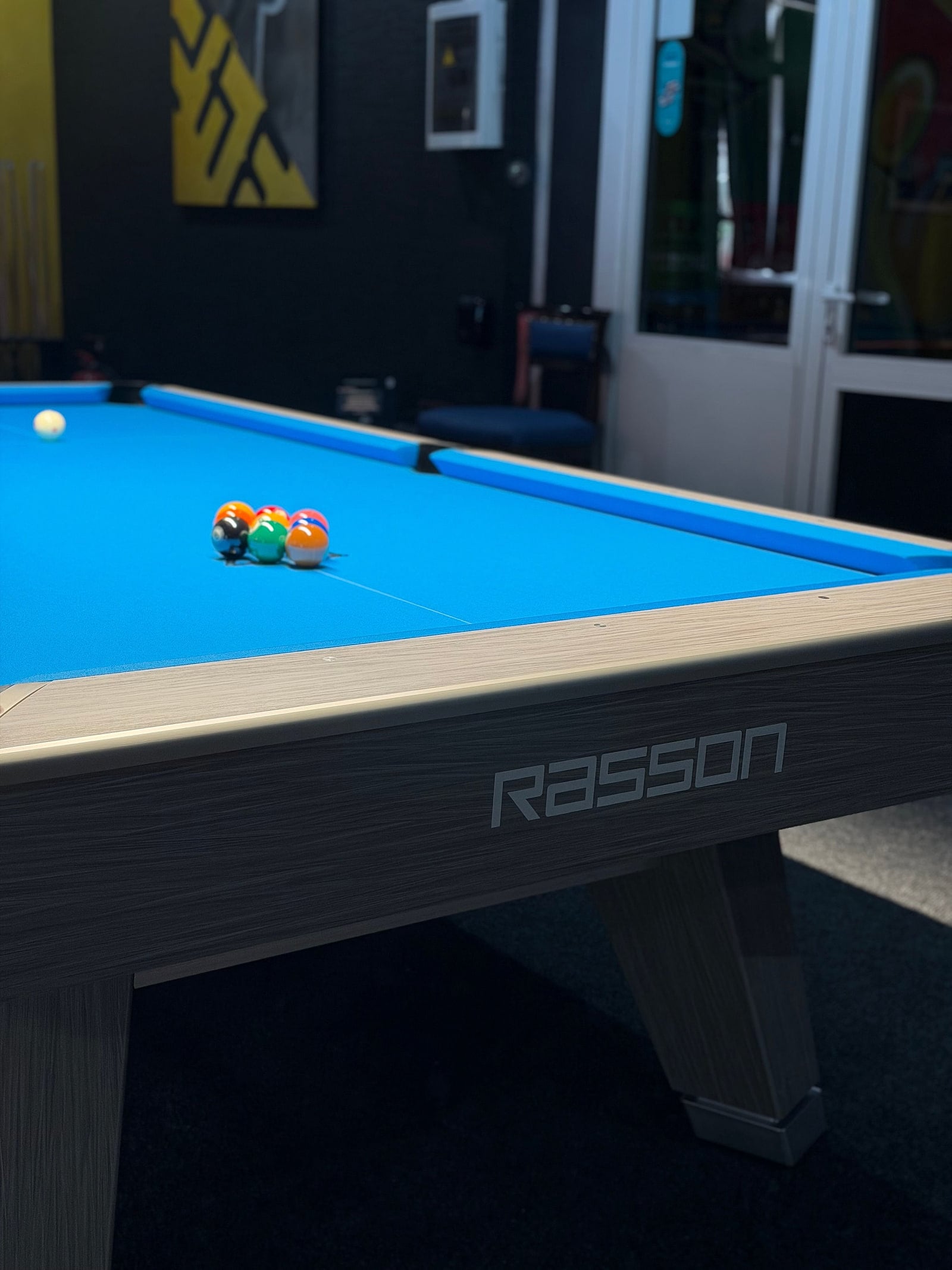The corner of a Rasson, racked with the cue ball